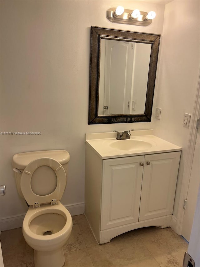 bathroom with tile patterned floors, vanity, a baseboard heating unit, and toilet