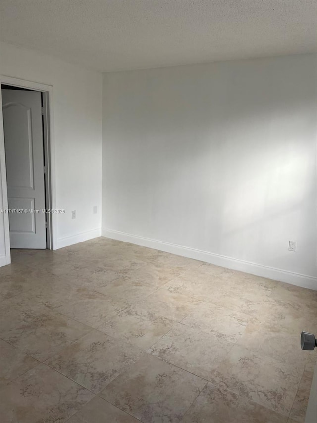 empty room featuring a textured ceiling