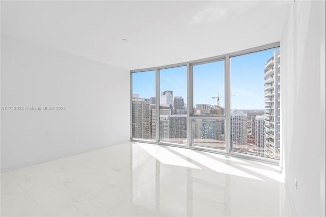 empty room featuring floor to ceiling windows and a wealth of natural light