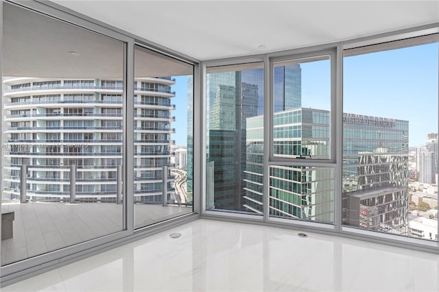 unfurnished room with tile patterned flooring and expansive windows