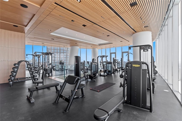 workout area featuring a wall of windows and wooden ceiling