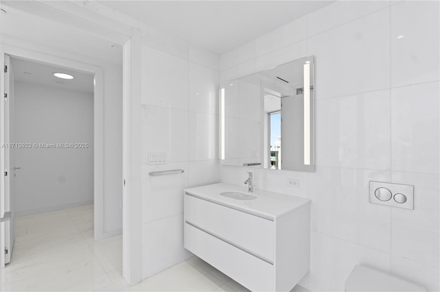 bathroom with tile walls and vanity