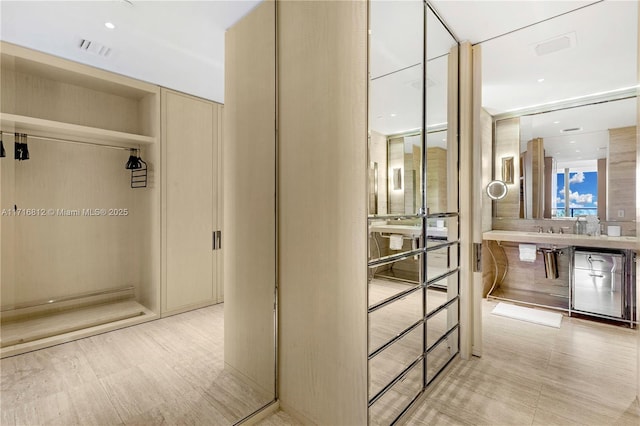 bathroom with wine cooler and sink