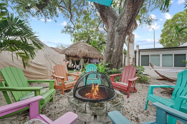 exterior space with a gazebo and a fire pit