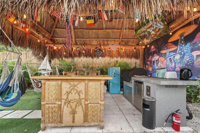 view of patio with a gazebo, exterior bar, and grilling area