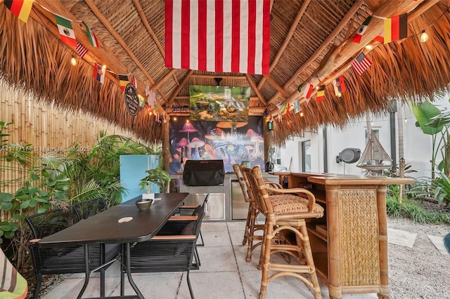 view of patio / terrace featuring a gazebo and an outdoor bar