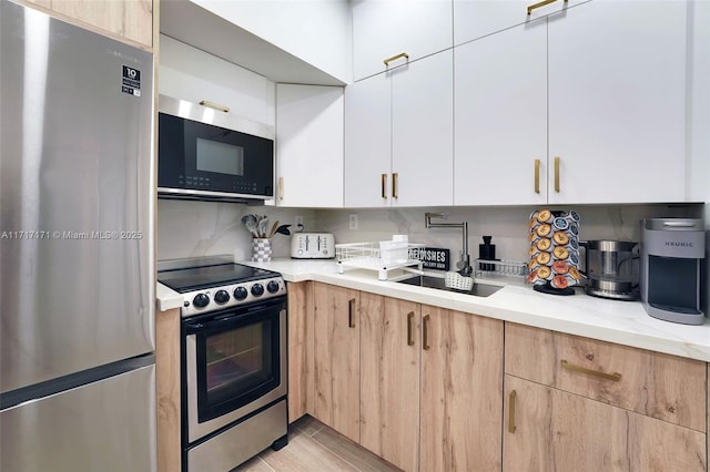 kitchen featuring stainless steel fridge, white cabinetry, light stone counters, range with electric stovetop, and decorative backsplash