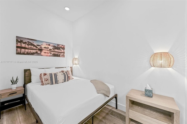 bedroom with dark wood-type flooring