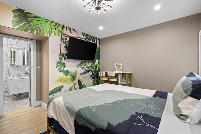 bedroom with hardwood / wood-style flooring, sink, and connected bathroom