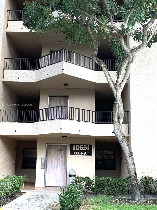 entrance to property featuring stucco siding