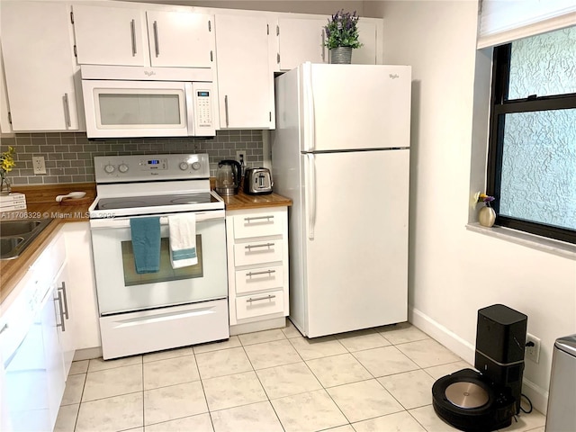 kitchen featuring light tile patterned floors, white appliances, white cabinetry, and decorative backsplash