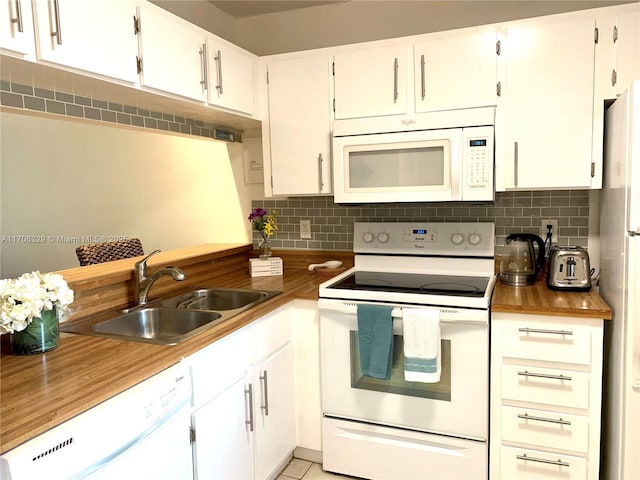 kitchen with tasteful backsplash, sink, white cabinets, and white appliances