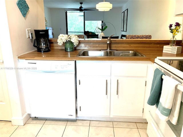 kitchen featuring white cabinets, range, white dishwasher, and sink