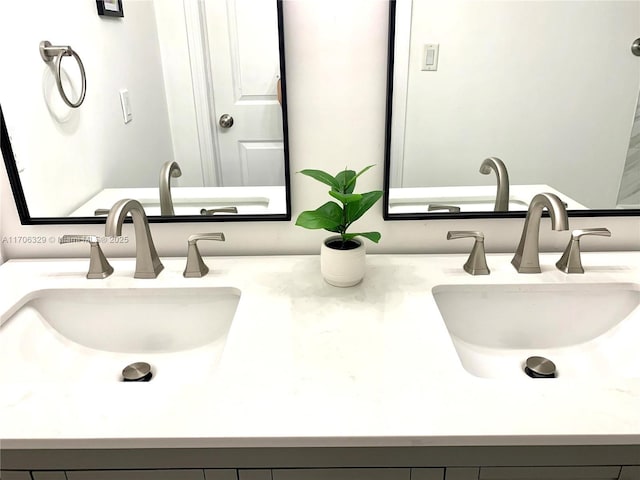 bathroom with a sink and double vanity