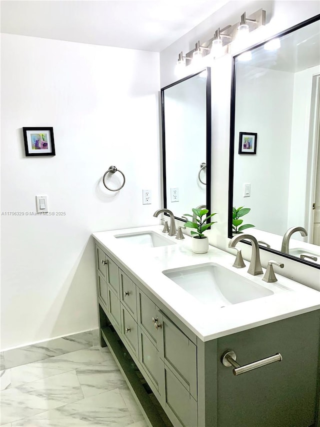 bathroom with marble finish floor, double vanity, and a sink