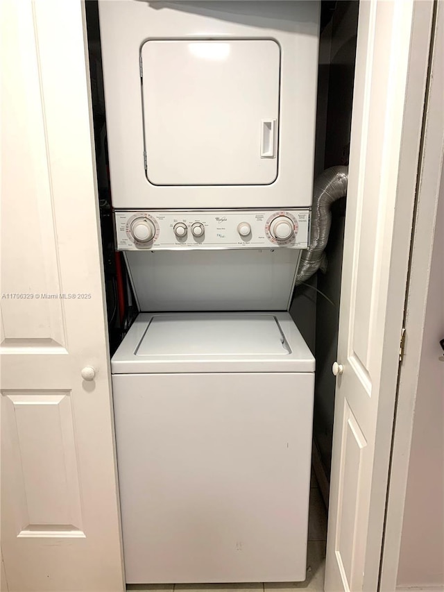 laundry area featuring stacked washer and clothes dryer