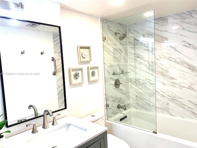 full bathroom featuring vanity, toilet, and bath / shower combo with glass door