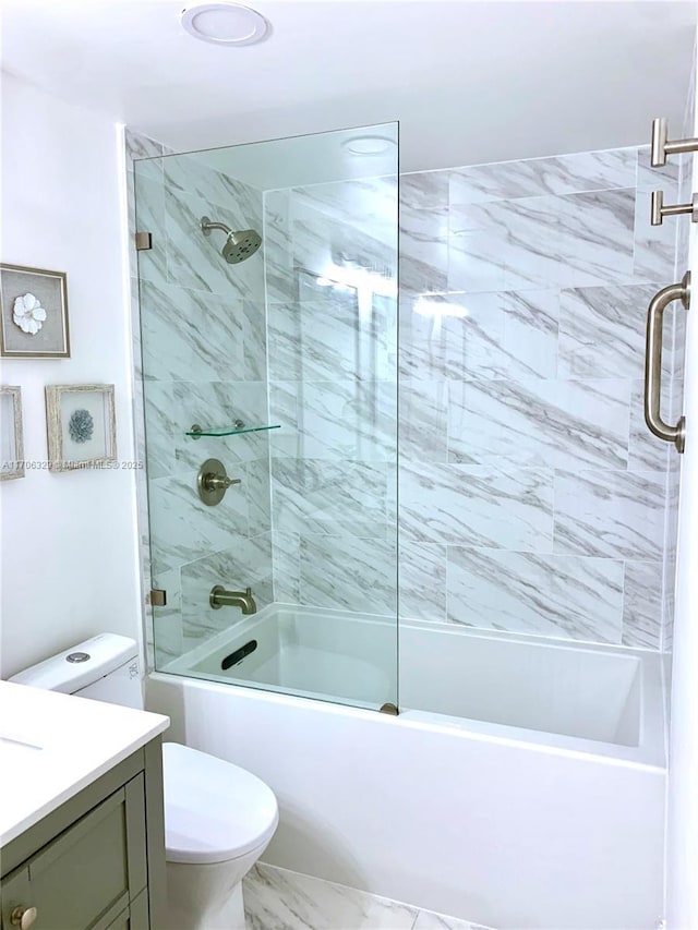 bathroom with toilet, marble finish floor, combined bath / shower with glass door, and vanity