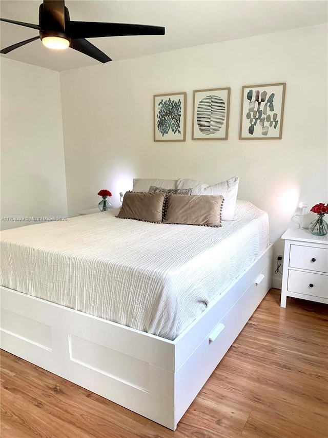 bedroom with hardwood / wood-style floors and ceiling fan