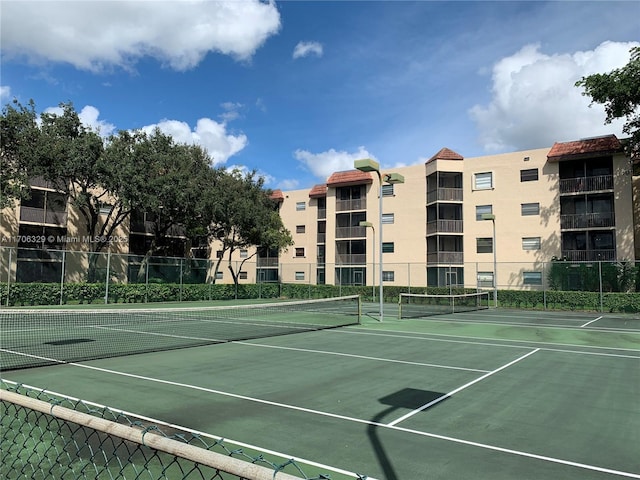 view of sport court featuring fence