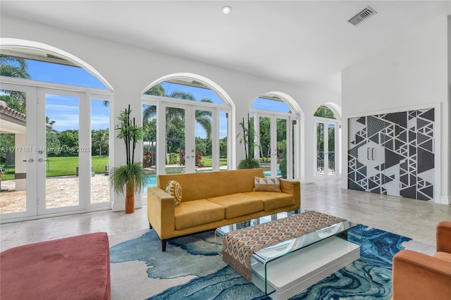 interior space with french doors, a healthy amount of sunlight, and visible vents