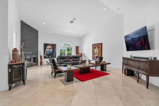 living area featuring high vaulted ceiling, recessed lighting, visible vents, and baseboards