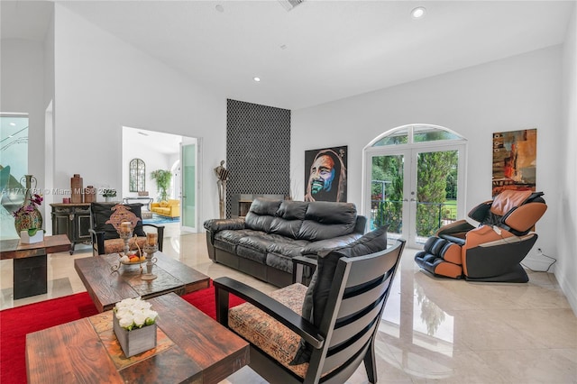 living area featuring a towering ceiling, french doors, and recessed lighting