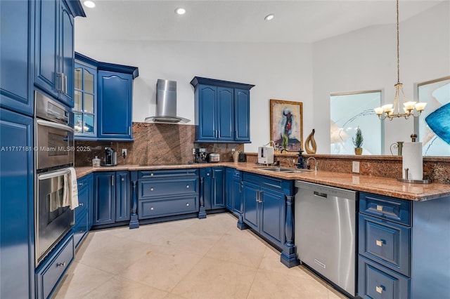 kitchen featuring wall chimney exhaust hood, a sink, blue cabinets, and stainless steel appliances