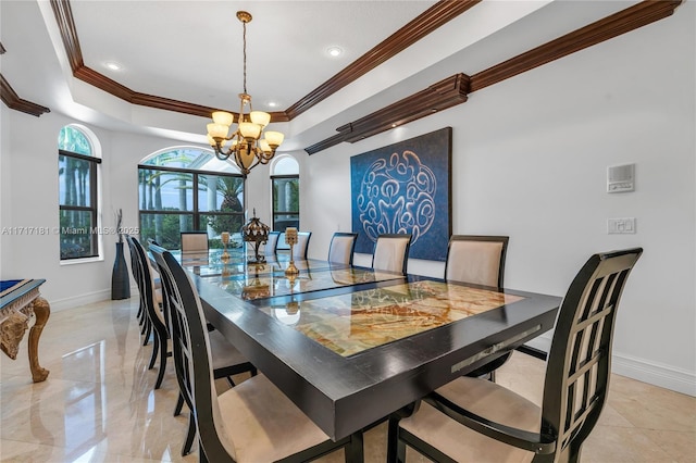 dining space with a raised ceiling, crown molding, a chandelier, and baseboards