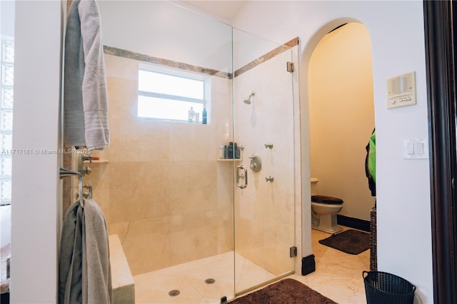 full bathroom with toilet and a stall shower