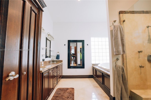 bathroom featuring double vanity, a sink, a bath, baseboards, and walk in shower