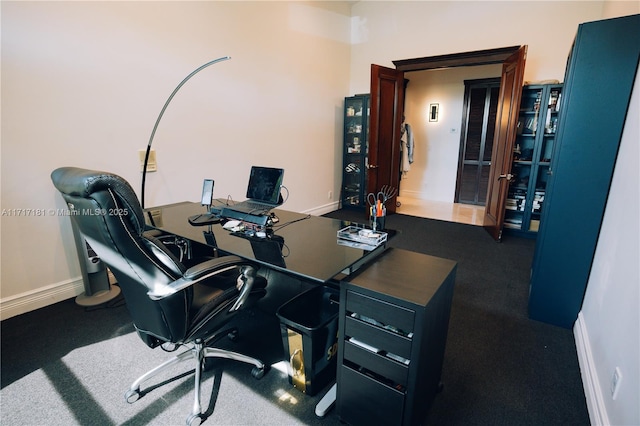 office space with dark carpet and baseboards