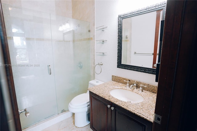 bathroom with a stall shower, vanity, and toilet