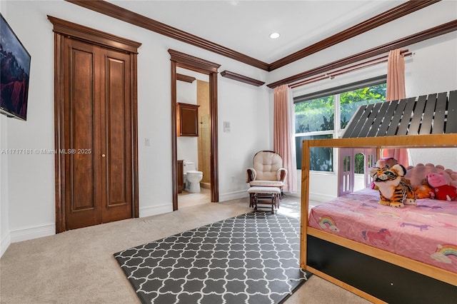 bedroom with recessed lighting, light carpet, baseboards, ornamental molding, and ensuite bath