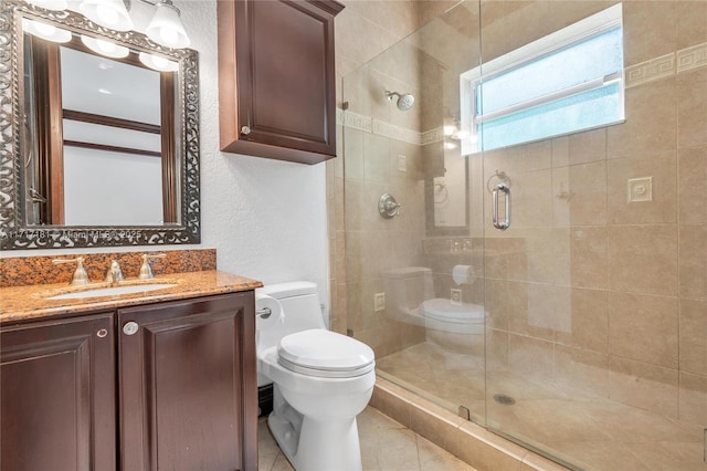 bathroom featuring tile patterned floors, a shower stall, toilet, and vanity