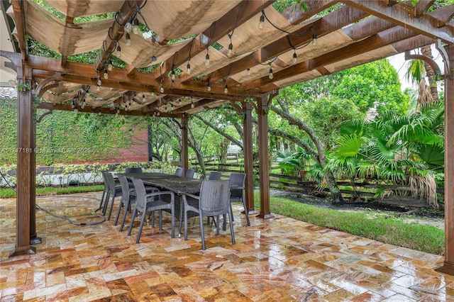 view of patio featuring outdoor dining space and a pergola