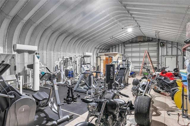 gym with lofted ceiling and metal wall