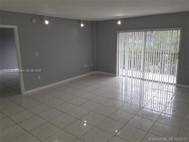 spare room featuring light tile patterned floors