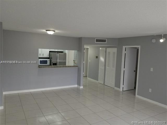 unfurnished living room with light tile patterned floors and a textured ceiling