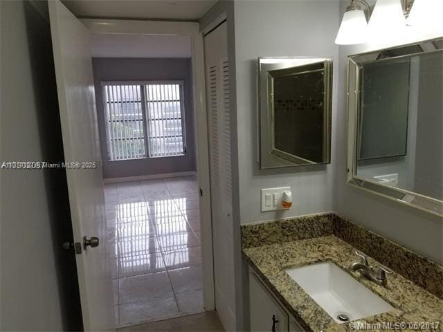 bathroom featuring tile patterned flooring and vanity