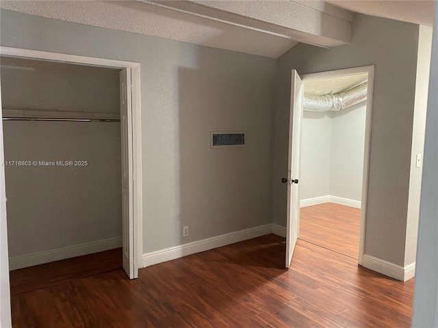 unfurnished bedroom featuring hardwood / wood-style floors and a textured ceiling