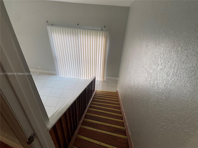 staircase featuring tile patterned floors