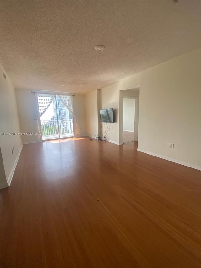 empty room featuring hardwood / wood-style floors and a textured ceiling