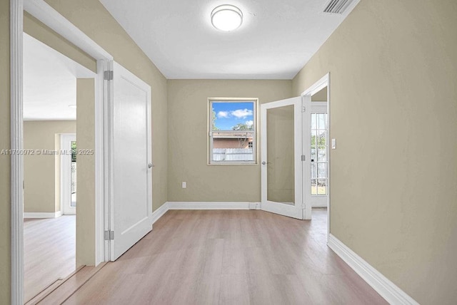 interior space with french doors and light wood-type flooring