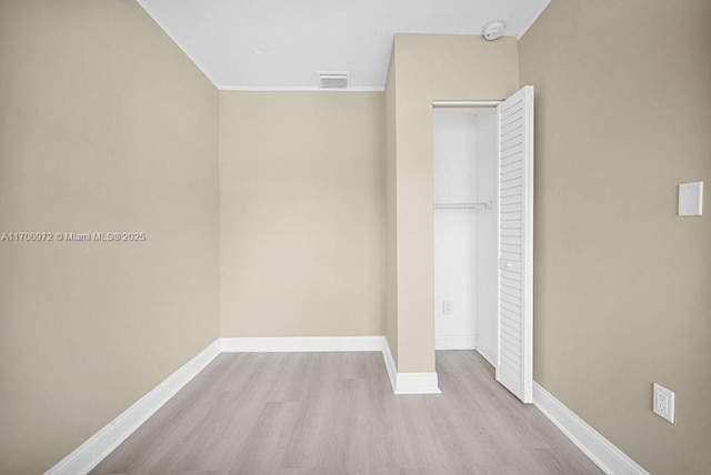 unfurnished bedroom featuring a closet and light hardwood / wood-style floors