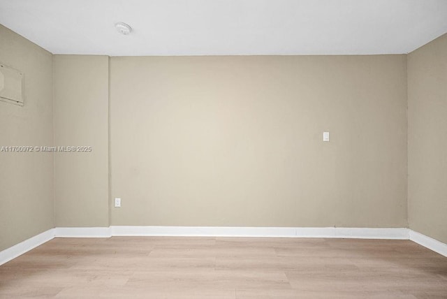 spare room featuring light hardwood / wood-style floors