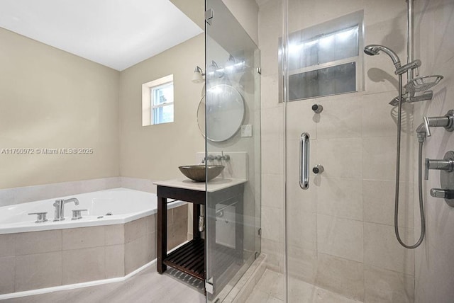 bathroom featuring separate shower and tub and sink