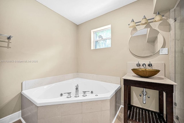 bathroom with vanity and a relaxing tiled tub