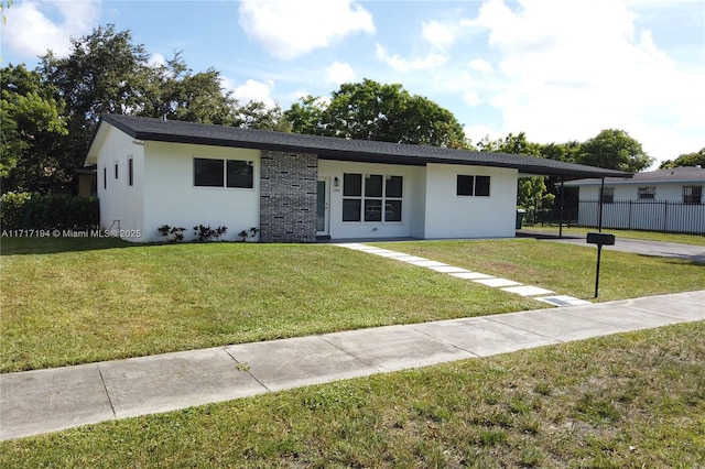 ranch-style house with a carport and a front lawn