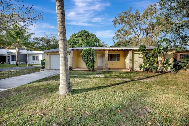 single story home featuring a front yard and a garage